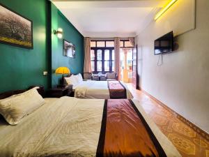 Postel nebo postele na pokoji v ubytování Nguyễn Hùng Hotel Sapa