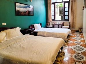 Postel nebo postele na pokoji v ubytování Nguyễn Hùng Hotel Sapa