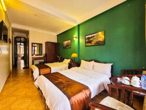 Postel nebo postele na pokoji v ubytování Nguyễn Hùng Hotel Sapa