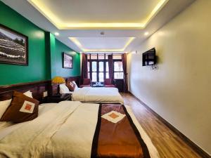 Postel nebo postele na pokoji v ubytování Nguyễn Hùng Hotel Sapa