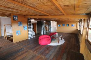 a room with a red bag on a wooden floor at Seabreeze Hostel Bali in Canggu