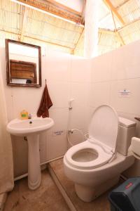 a bathroom with a toilet and a sink at Seabreeze Hostel Bali in Canggu