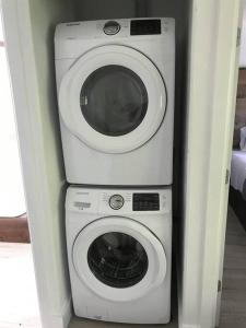 a dryer and a washing machine in a room at Cozy Cottage • King Bed • Grove • Kayaks • Boat Parking in Grove