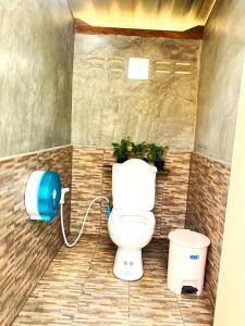 a bathroom with a toilet in a room at Asama Bungalow in Ko Lanta