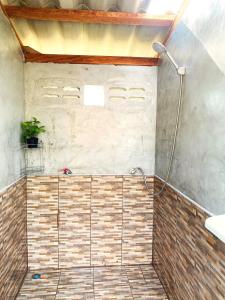 a bathroom with a shower with a plant in it at Asama Bungalow in Ko Lanta