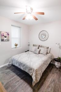 a bedroom with a bed and a ceiling fan at Convenient 2 bedroom 1 bathroom in Saint Louis