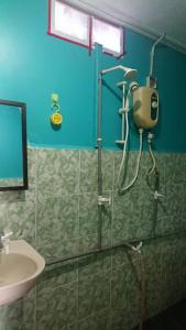 a bathroom with a shower and a sink at Barook Chalet in Mersing