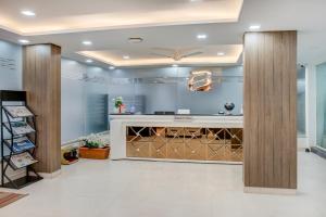 a wine tasting room with a wall of wine bottles at ECKO Sterling Inn Near Bangalore International Airport in Bangalore