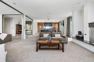 a living room with a couch and a table at Taupo Penthouse in Taupo