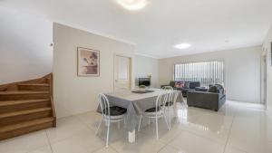 a living room with a table and a couch at Anne Street Monte - Vista in Port Macquarie