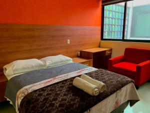a bedroom with a bed and a red chair at CASA GUME - Departamentos con 2 habitaciones para 4 personas in Oaxaca City +21 photos