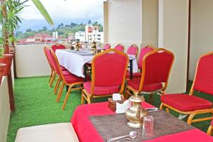 una sala da pranzo con un tavolo e sedie rosse di Hotel Airport Gurkha a Kathmandu