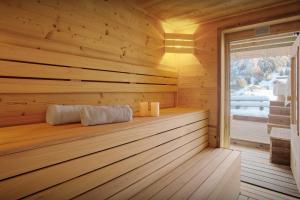 a sauna with wooden walls and a window at Chalet Batieu - OVO Network in La Clusaz