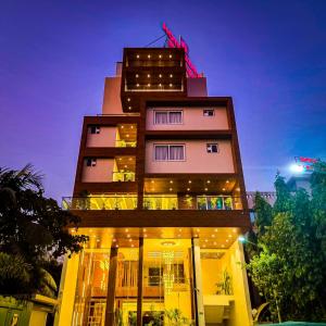 a tall building with lights on top of it at Hotel Aditya Mansingh Inn in Somnath