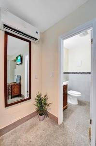 a bathroom with a toilet and a sink and a mirror at Hollywood Broadwalk Beach Walk Holiday Retreat in Hollywood