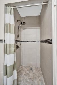 a shower with a shower curtain in a bathroom at Hollywood Broadwalk Beach Walk Holiday Retreat in Hollywood