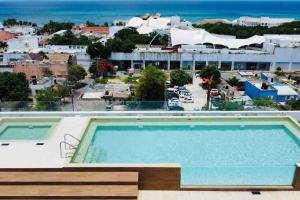 a pool on the roof of a hotel with a view at Ocean view apartment close to de beach and 5th Av in Playa del Carmen