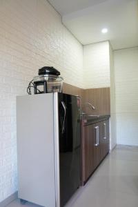 a kitchen with a refrigerator in a room at Doris Seminyak Studio in Seminyak