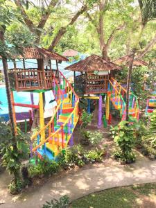 a playground with a colorful slide in a park at Sea Forest Resort in Sibulan