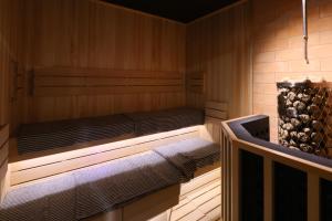 a sauna with a bed in a wooden room at Dormy Inn Kanazawa Natural Hot Spring in Kanazawa