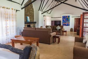 ein Wohnzimmer mit Sofas, einem Tisch und einem Sofa in der Unterkunft Ndoto House-Maanzoni ,Athi River by Nest & Nomad in Machakos