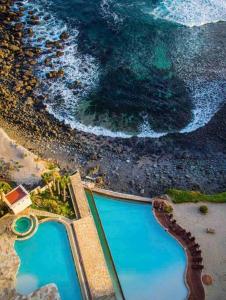 an aerial view of a swimming pool on the beach at Ocean Front Condo @ Las Olas Grand in Rosarito