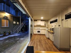 a kitchen with a refrigerator and a staircase in it at Swing & Pillows - Golden Lodge Tanah Rata, Cameron Highland in Tanah Rata
