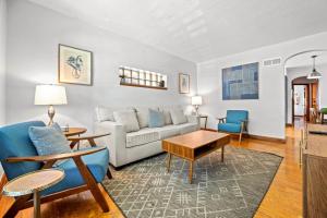 a living room with a couch and a table and chairs at 1 bedroom-City Livin in Saint Louis +4 photos