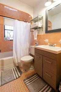 a bathroom with a toilet and a sink and a mirror at Cozy 1-bedroom apartment with free parking in Saint Louis