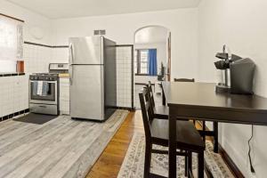 a kitchen with a refrigerator and a table and chairs at Cozy 1-bedroom apartment with free parking in Saint Louis +7 photos