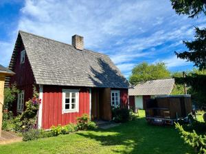 a red house with a gray roof at Suurekivi külalistemaja in Reigi