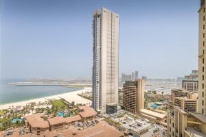 a view of a city with a beach and a tall building at Modern and new studio in Murjan, JBR in Dubai