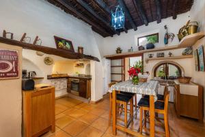a kitchen with a table and chairs in a room at Finca Son Favar Capdepera in Capdepera