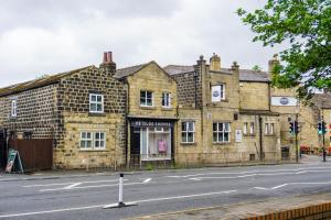 an old brick building on the side of a street at Headingley 2 Bedroom first floor cottage flat Near Universities shops& Park in Leeds