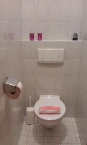 ein Bad mit einem WC und einem rosa Handtuch darauf in der Unterkunft Landhaus Hirterhütte in Abtenau