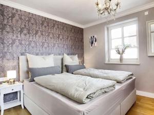 Postel nebo postele na pokoji v ubytování Ostseeflair-im-Ferienhaus-Flair-am-Meer