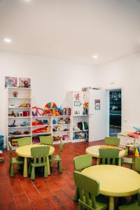 a classroom with tables and chairs and shelves at Hotel Marina in Lido di Jesolo