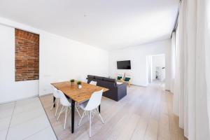 a dining room with a table and a couch at Bohéme Apartments Charle's Square in Prague