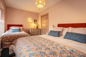 sypialnia z 2 łóżkami i niebieskimi poduszkami w obiekcie Luxury House Waterford City Centre w mieście Waterford
