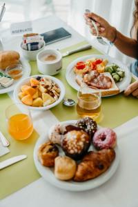 a table topped with plates of different types of pastries at Hotel Adlon in Lido di Jesolo