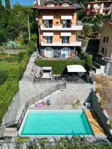 a house with a swimming pool in front of a house at Villa Nogara in Menaggio