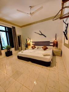 a bedroom with a large bed in a room at Ocean Cottage Maldives in Thulusdhoo
