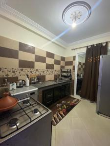 a kitchen with a stove and a refrigerator at khouribga in Khouribga