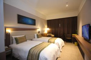 Uma cama ou camas num quarto em Grace Hotel