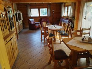 a dining room with tables and chairs in a cabin at Ferienwohnung Bermbach in Weilburg