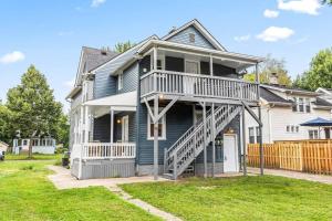 a large house with a staircase on the side of it at Peaceful Studio Flat near Downtown Mount Clemens in Mount Clemens
