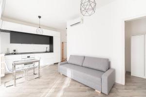 uma sala de estar com um sofá e uma mesa em Appartamento: BuenosAires79 em Milão