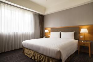 Postel nebo postele na pokoji v ubytování Fushin Hotel Taipei