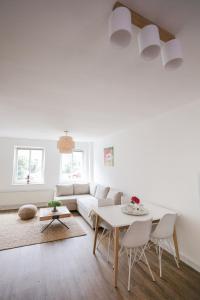 a living room with a white couch and a table at Wohnen am Park in Lübeck