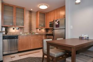 a kitchen with stainless steel appliances and a wooden table at Residence Inn Charlotte Concord in Concord